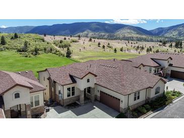 Beautiful exterior of a house with mountain views and a well-manicured lawn in a serene neighborhood at 4502 Echo Cliff Ln, Larkspur, CO 80118