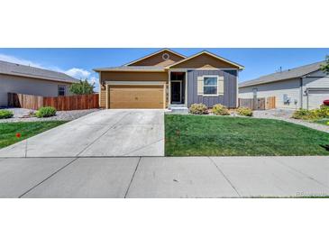 Charming home featuring a two-car garage, well-manicured lawn, and inviting curb appeal at 7433 Ellingwood Cir, Frederick, CO 80504
