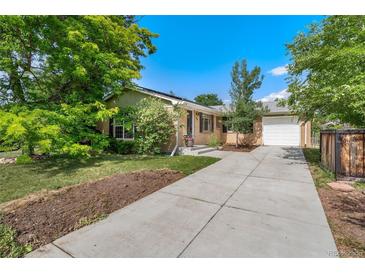 Charming brick home featuring a long driveway, attached garage, and well-manicured front yard at 216 Hemlock, Broomfield, CO 80020