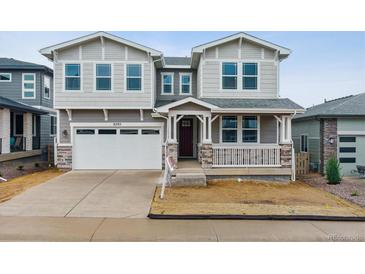 Charming two-story home with a covered porch and a two-car garage at 8205 Cokedale Cir, Littleton, CO 80125
