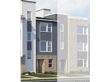 Modern townhome showcasing vertical and horizontal siding and brick facade, creating an eye-catching street view at 14279 Currant St, Broomfield, CO 80020