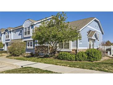 Charming blue townhome with stone accents and well-maintained landscaping; perfect for comfortable living at 5873 Ceylon St # E, Denver, CO 80249