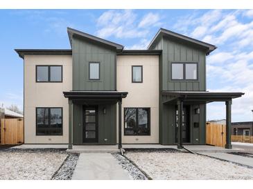 Modern two-story home featuring a stylish exterior with a combination of light and dark siding under a partly cloudy sky at 1306 Yates St, Denver, CO 80204