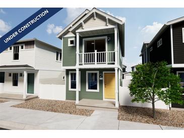 Charming two-story home with a yellow door and a balcony at 13079 E 103Rd Pl, Commerce City, CO 80022