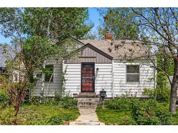 Charming home with white siding, a well-maintained yard, and a welcoming front entrance at 5674 S Prescott St, Littleton, CO 80120