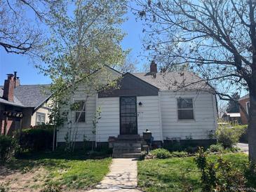 Charming single story home with a well maintained lawn, walkway and mature shade trees at 5674 S Prescott St, Littleton, CO 80120