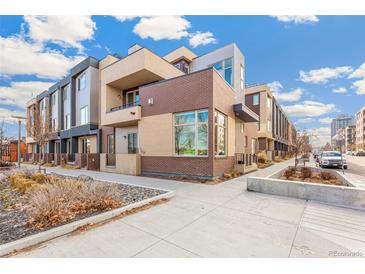 Modern townhome with brick exterior and landscaped walkway at 1694 Quitman St, Denver, CO 80204