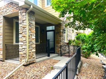 Charming home with a stone front porch and black metal railings at 11282 Osage N Cir # F, Northglenn, CO 80234
