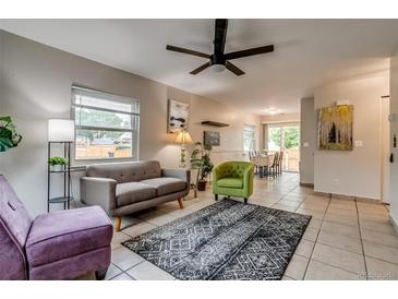 Bright living room features stylish furnishings, a ceiling fan, and neutral tile flooring at 999 Osceola St, Denver, CO 80204