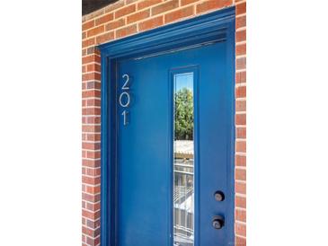 A vibrant blue front door with glass pane and a clear view of the property number 201 at 1 N Pearl St # 201, Denver, CO 80203