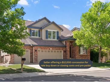 Two story home with brick and beige siding, three car garage, and mature trees at 11842 Altura St, Commerce City, CO 80603