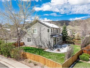 A charming backyard with a green lawn and a patio set, perfect for outdoor dining and entertaining at 9407 W Gibraltar Pl, Littleton, CO 80127