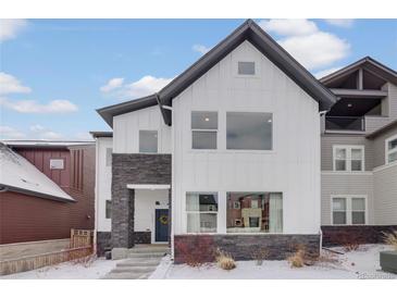 Beautiful two-story home with a modern white facade and a stone accent wall at 1933 W 165Th Way, Broomfield, CO 80023