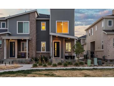 Charming two-story townhome with modern gray siding and brick accents at 24333 E 41St Ave, Aurora, CO 80019