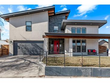 Contemporary two-story home featuring a bright red front door, a gray garage door, and a covered porch at 745 S Eliot St, Denver, CO 80219