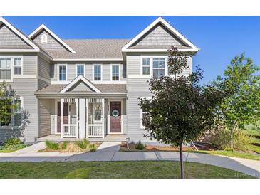 Charming two-story townhome with a covered front porch and gray siding at 1678 Wright Aly, Erie, CO 80516