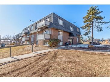 Two-story building exterior with walkway and landscaping at 50 E Highline Cir # 102, Centennial, CO 80122