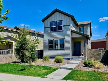 Charming two-story home featuring a landscaped front yard and a welcoming entrance, enhancing its curb appeal at 4770 N Jasper St, Denver, CO 80239
