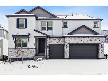 Modern two-story home featuring a two-car garage and stylish stone accents at 3340 Backdrop Ct, Castle Rock, CO 80108