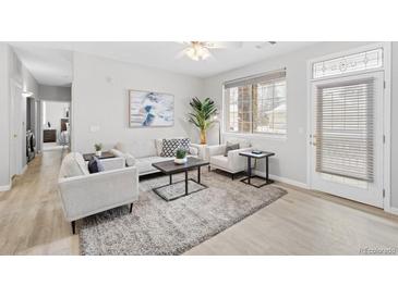 Bright living room with stylish furniture, decor, and lots of natural light at 10437 W Hampden Ave # 104, Lakewood, CO 80227