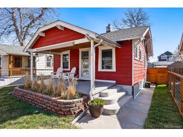 Charming red house featuring a cozy front porch with white chairs and landscaped brick garden bed at 4452 Zenobia St, Denver, CO 80212