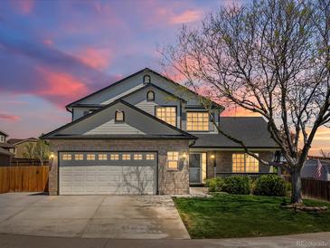 Charming two-story home featuring a spacious two car garage, landscaped front yard and inviting entrance at 13972 Hudson Way, Thornton, CO 80602