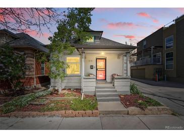 Charming home featuring a well-maintained front yard and inviting entry at sunset at 315 E Bayaud Ave, Denver, CO 80209
