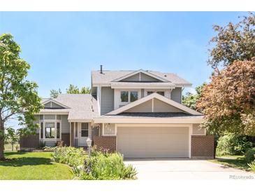 Charming two-story home with a well-manicured lawn and a two-car garage at 4547 Tally Ho Trl, Boulder, CO 80301