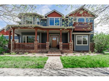 Charming two-story home featuring a spacious front porch, beautiful landscaping, and a welcoming entrance at 900 Wilshire Dr, Berthoud, CO 80513