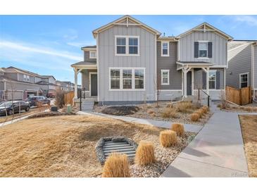 Charming two-story home with well-maintained lawn and inviting curb appeal on a sunny day at 11450 Booth Falls Ct, Parker, CO 80134