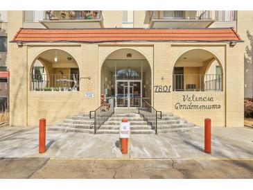 Valencia Condominiums brick entrance with arched entryways, stairs and railings plus signage and address at 7801 W 35Th Ave # 409, Wheat Ridge, CO 80033