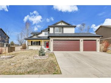 Charming two-story home with a three-car garage and well-maintained front yard at 5885 Kingsfield St, Castle Rock, CO 80104