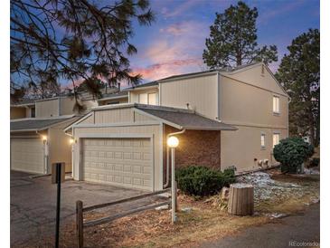 Inviting townhouse featuring an attached garage and classic brick accents, perfect for comfortable living at 2748 S Kenton Ct, Aurora, CO 80014