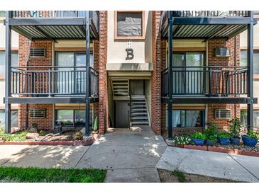 A brick apartment building with black metal balconies and access stairs for each unit at 5995 W Hampden Ave # 20B, Denver, CO 80227