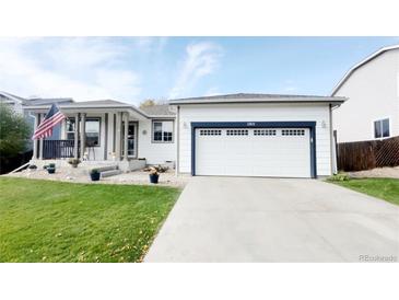 Charming single-Gathering home with a well-manicured lawn, two-car garage, and inviting front porch at 13871 Ivy St, Thornton, CO 80602