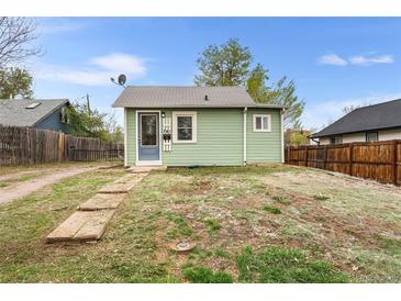 Charming single-story home featuring light green siding, a welcoming front door, and a compact yard at 741 Quitman St, Denver, CO 80204