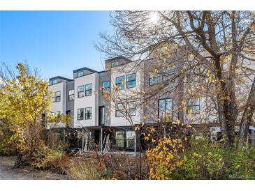 Modern 3-story townhome building with light gray and white exterior at 1416 Pierce St, Lakewood, CO 80214