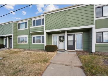 Green townhome exterior with landscaping and walkway at 906 S Peoria St, Aurora, CO 80012