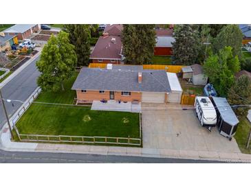 Aerial view of brick home featuring a well-maintained lawn and a long driveway for parking at 5320 W 62Nd Ave, Arvada, CO 80003