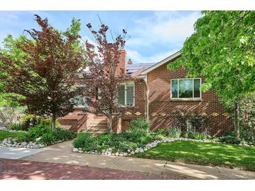 Charming brick home featuring a walkway, manicured lawn and attractive landscaping at 4000 Irving St, Denver, CO 80211