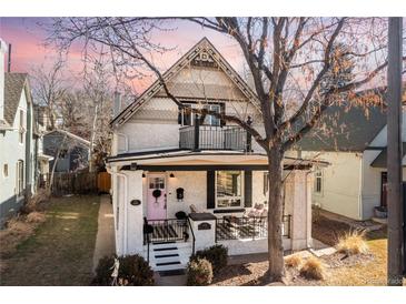 Charming two-story home with a covered front porch and decorative details under the gables at 858 S Emerson St, Denver, CO 80209