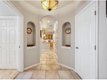 Inviting hallway featuring an archway and tiled floor that leads to an open kitchen at 1100 Cherokee St # 304, Denver, CO 80204