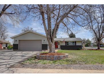 Charming single-story home with a well-manicured lawn, brick accents, and a spacious driveway leading to an attached garage at 6272 S Garfield Dr, Centennial, CO 80121
