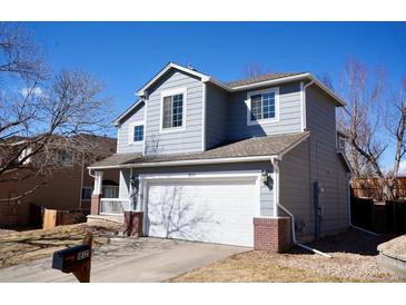Charming two-story home features a well-maintained yard and attached two car garage at 18121 E Adriatic Pl, Aurora, CO 80013