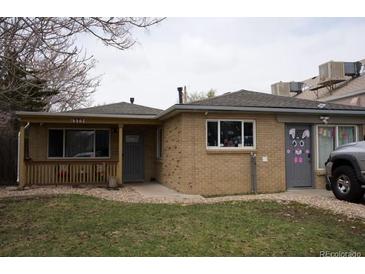 Charming single-story home with brick exterior, covered porch, and well-maintained front yard at 1375 N Iola St, Aurora, CO 80010