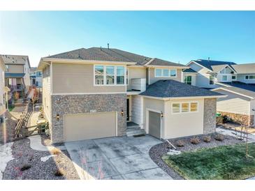 Beautiful two-story home featuring stone accents, a two-car garage, and professionally landscaped yard at 6733 S Waterloo Ct, Aurora, CO 80016