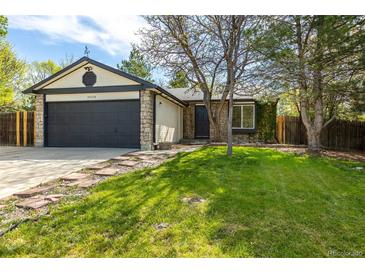 Charming single Gathering home featuring stone accents, a two-car garage, and a well-manicured front lawn at 11524 Marshall Ct, Broomfield, CO 80020