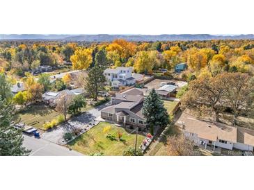 Stunning aerial view of home with beautiful, lush landscaping and mature trees in the surrounding neighborhood at 1945 Yarrow St, Lakewood, CO 80214