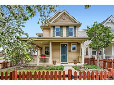 Charming two-story home with front porch and vibrant red picket fence enhancing curb appeal at 2538 Central Park Blvd, Denver, CO 80238