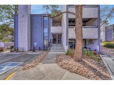 Exterior view of the condo complex with well-maintained landscaping and visible unit entrances at 6420 S Dayton St # J07, Englewood, CO 80111